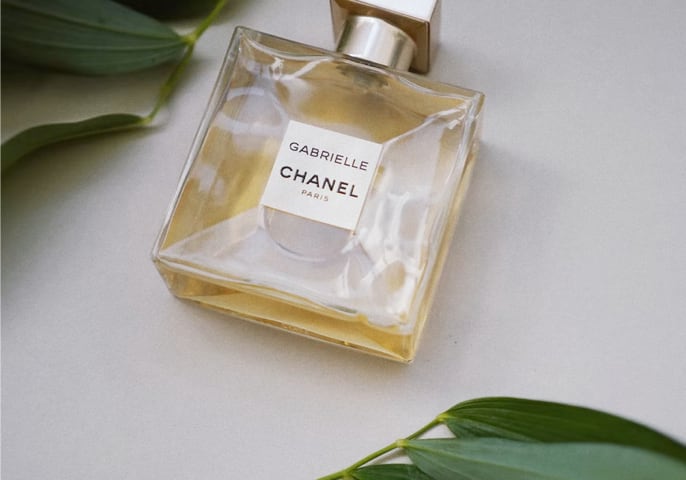 A square perfume bottle with a label that says 'Gabrielle Chanel Paris'